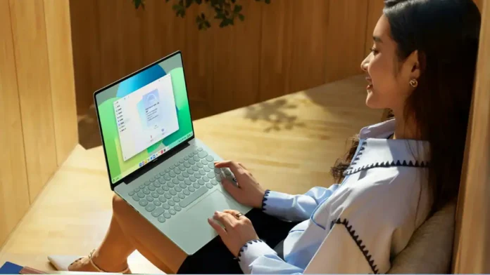 Huawei MateBook 14 HarmonyOS laptop being used by person while seated indoors with display active
