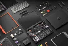Framework Laptop 13 Pro Launches With Core Ultra Series 3, and 20+ Hour Battery Framework Laptop 13 Pro fully disassembled layout showing internal components including motherboard, cooling fan, battery, keyboard, display panel, ports modules, and replaceable expansion cards arranged on a dark surface