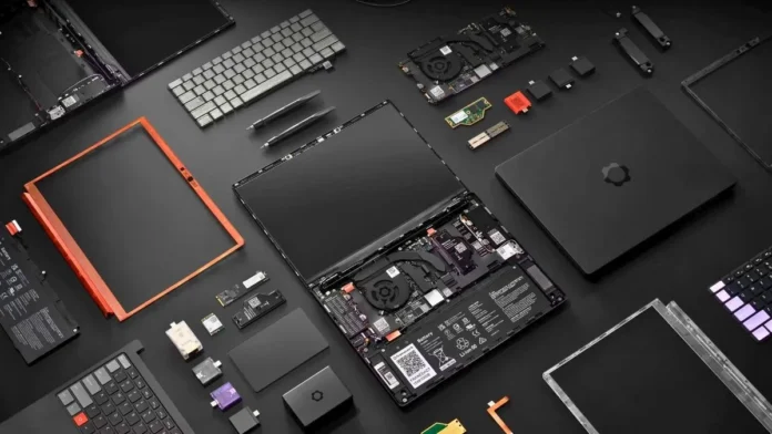 Framework Laptop 13 Pro fully disassembled layout showing internal components including motherboard, cooling fan, battery, keyboard, display panel, ports modules, and replaceable expansion cards arranged on a dark surface
