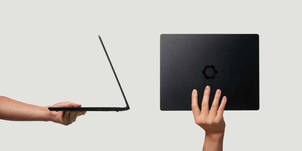 Framework Laptop 13 Pro held in hand showing ultra-thin chassis from side view alongside top view with minimal branding, emphasizing lightweight and portable design