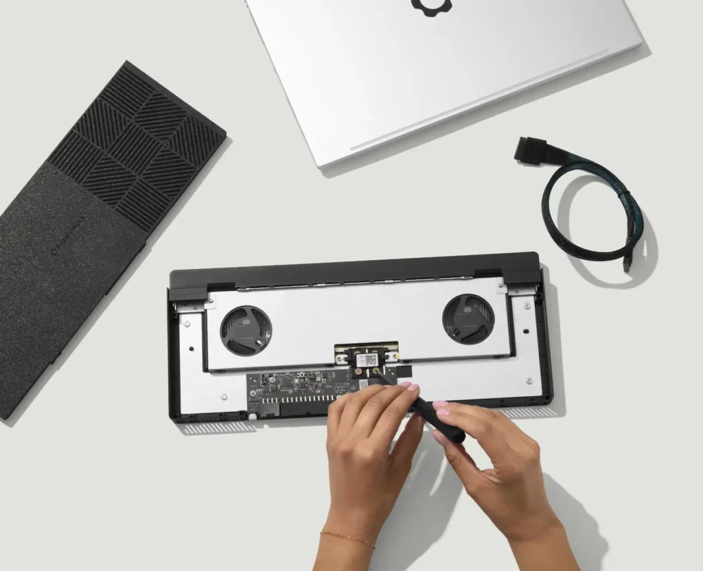 Framework OCuLink 8i Dev Kit installation showing internal components cooling fans and cable connection inside laptop