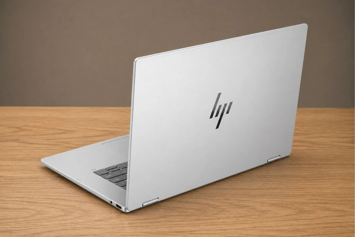Rear view of HP OmniBook 7 Flip with minimalist silver finish and centered HP logo.
