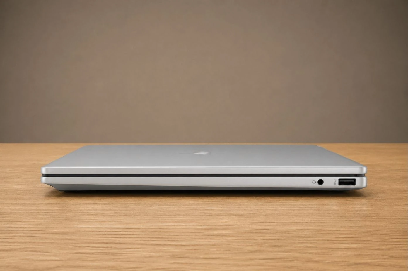 HP OmniBook 7 Flip closed showing slim profile with visible USB port and audio jack on the side.