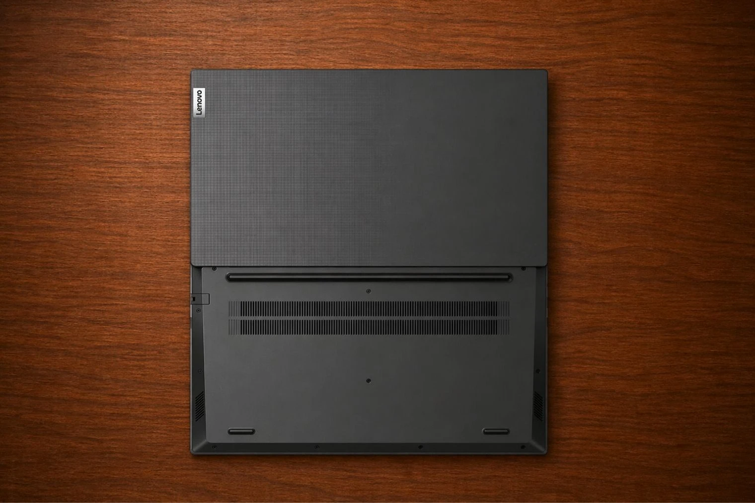 Bottom view of Lenovo V15 Gen 4 showing ventilation grills, speakers, and base structure layout.