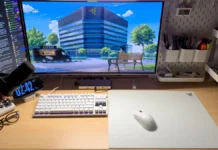 Razer Atlas Pro is World’s Thinnest Glass Mouse Mat at 1.9mm Razer Atlas Pro mouse mat placed on wooden desk with keyboard monitor and accessories arranged neatly