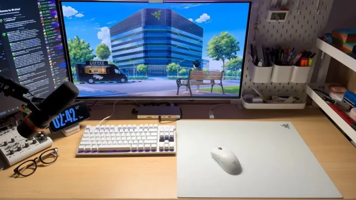 Razer Atlas Pro mouse mat placed on wooden desk with keyboard monitor and accessories arranged neatly