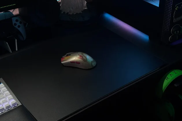 Razer Atlas Pro mouse mat in dark gaming environment with RGB lighting and gaming mouse on surface