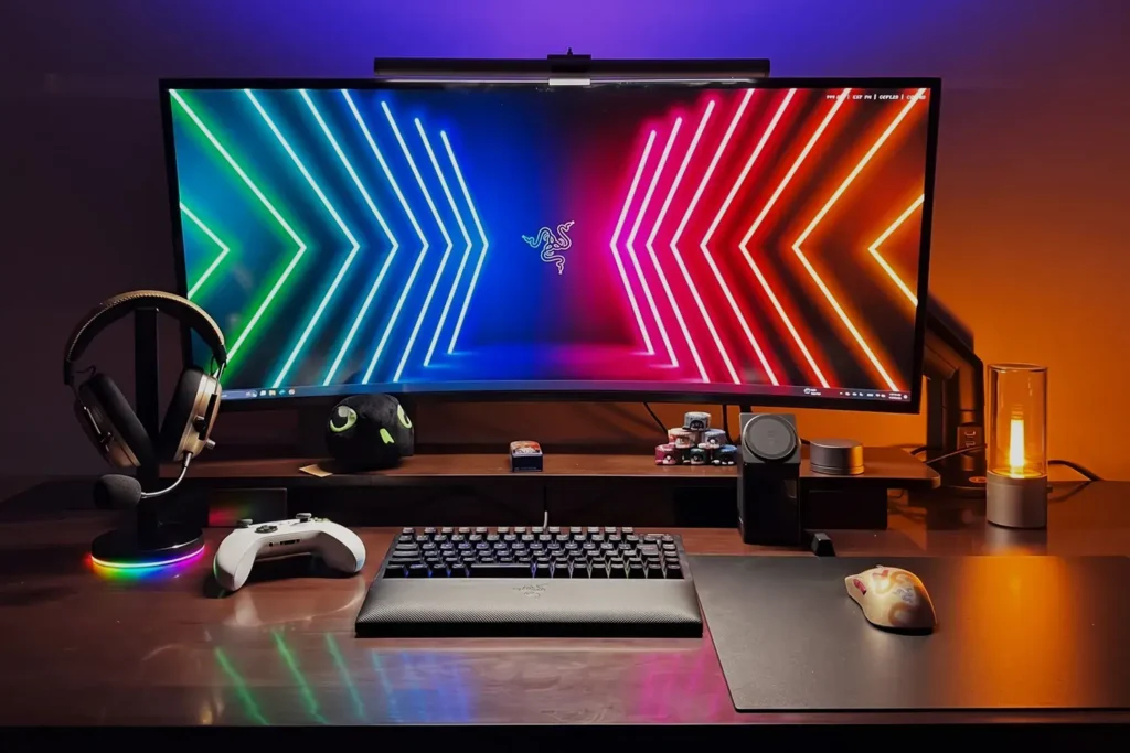 Razer Atlas Pro mouse mat used in RGB gaming setup with curved monitor keyboard and lighting effects