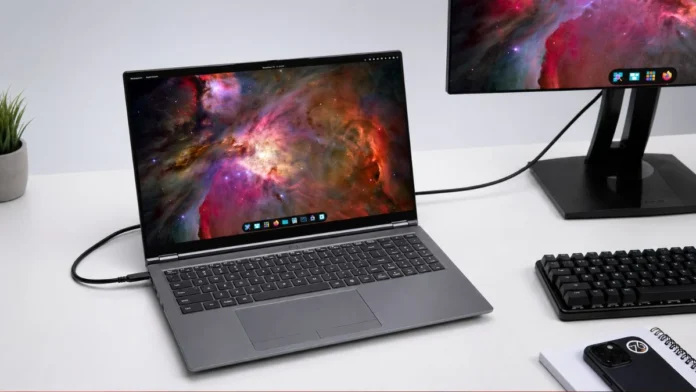System76 Pangolin Pro laptop connected to external display with keyboard and desk setup