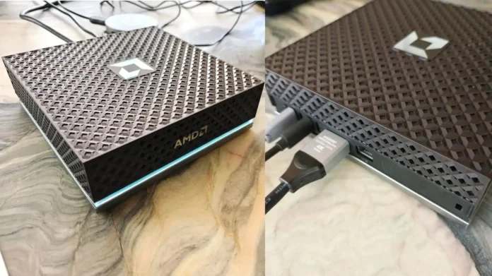 AMD Ryzen AI Halo Box mini PC with textured top panel and illuminated front edge placed on desk