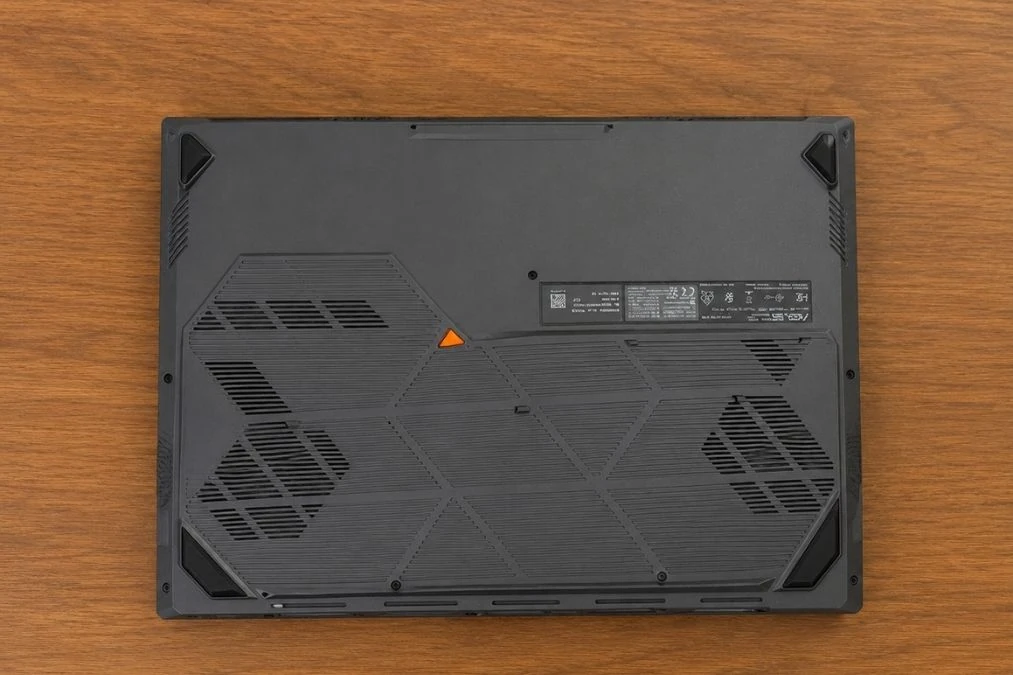 ASUS TUF Gaming F16 Review: Popular Gaming Tested 32 Bottom side of ASUS TUF Gaming F16 showing ventilation layout and cooling vents.