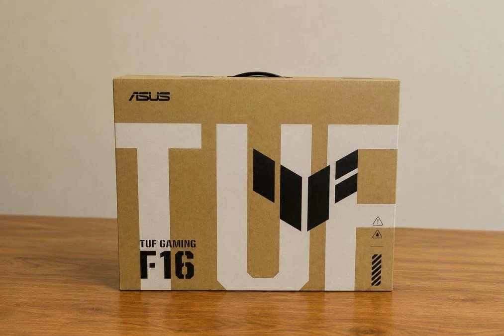 ASUS TUF Gaming F16 Review: Popular Gaming Tested 2 ASUS TUF Gaming F16 retail packaging placed on a wooden table.