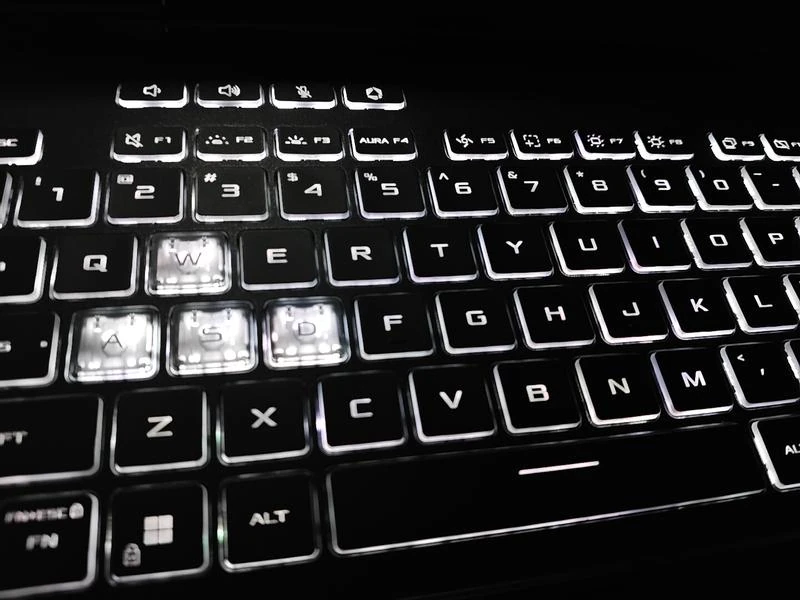 ASUS TUF Gaming F16 Review: Popular Gaming Tested 42 RGB backlit keyboard of ASUS TUF Gaming F16 with illuminated WASD keys.