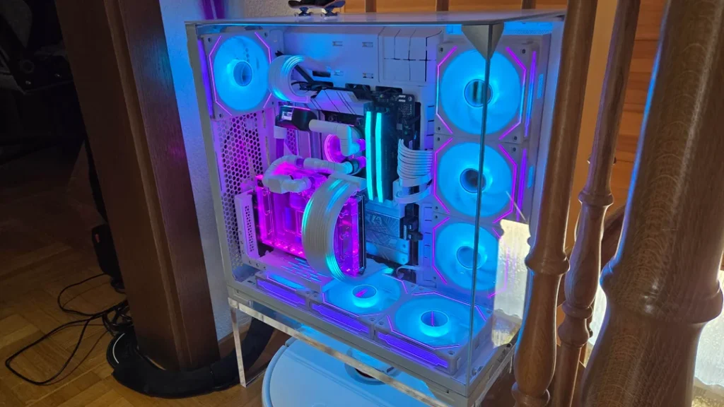 White custom gaming PC featuring a hardline liquid-cooling loop, RGB fans, and Ryzen 7 7800X3D hardware