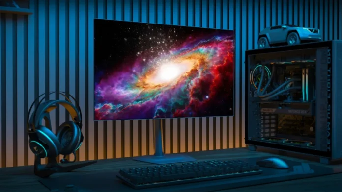 Gigabyte GO27Q24G OLED gaming monitor displayed in a desktop gaming setup beside a gaming PC