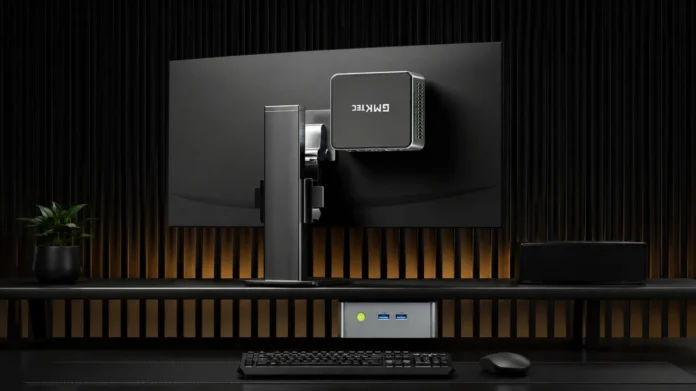 GMKtec NucBox M3 Pro mini PC mounted behind a monitor in a clean desktop workspace