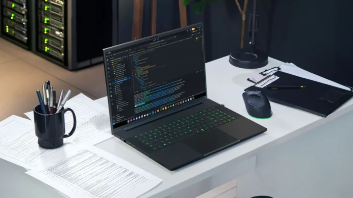 Razer Blade 18 laptop running code editor on a desk setup with gaming mouse