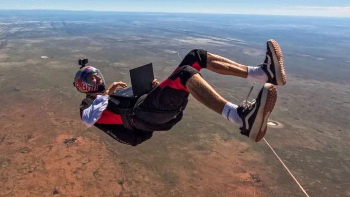Red Bull athlete Dani Román editing video on the ASUS ProArt GoPro Edition (PX13) laptop in mid-air above the desert.