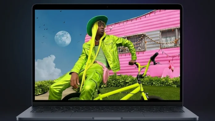 Apple MacBook Air M5 laptop displaying vibrant multimedia content on its 15.3-inch Liquid Retina display