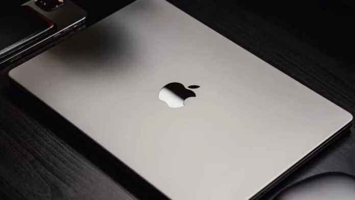 Silver Apple MacBook Pro laptop showing the black Apple logo on its lid.