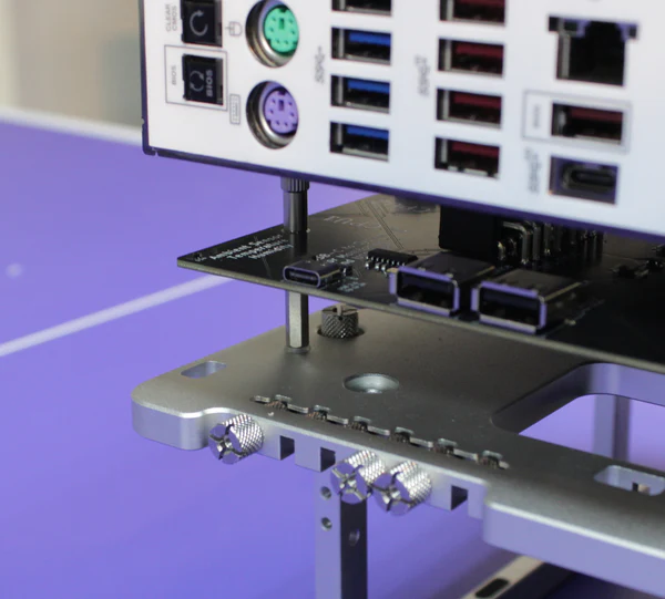 Close-up view of BENCHLAB 2 telemetry hardware showing USB ports and monitoring connections for PC benchmarking and diagnostics