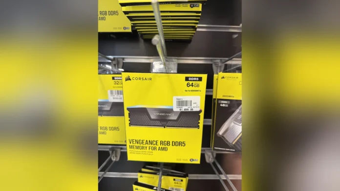 A retail shelf displaying Corsair Vengeance RGB DDR5 64GB and 32GB memory kits with price tags.