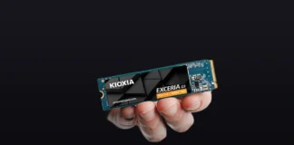 Kioxia EXCERIA G3 PCIe 5.0 SSD Lineup Expands with 4TB Option Hand holding the Kioxia EXCERIA G3 PCIe 5.0 NVMe SSD showing the label on a premium dark gradient background.
