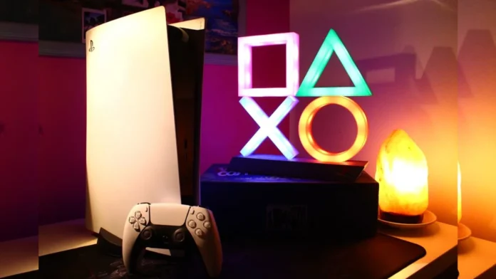 A gaming desk setup featuring a PlayStation 5 console, DualSense controller, and a glowing PlayStation symbols light.