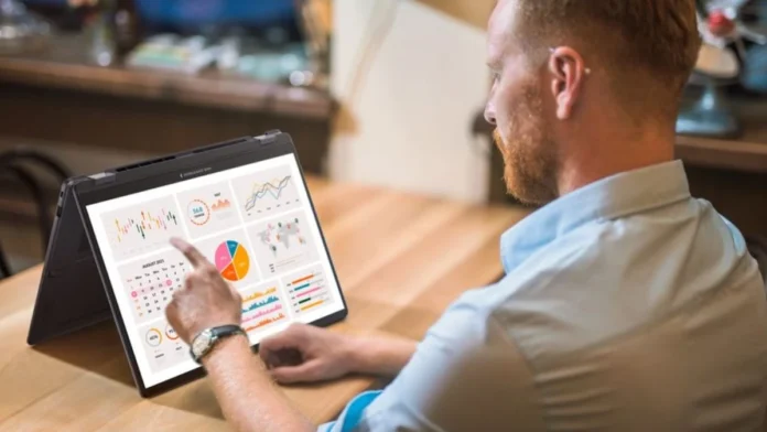 Professional using the ASUS ExpertBook B5 Flip G2 touchscreen display to view charts and business analytics