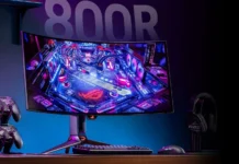 Asus ROG Swift OLED PG34WCDN Monitor Hits US Retailers at $1,299 Asus ROG Swift OLED PG34WCDN ultrawide OLED gaming monitor showcased in a desktop gaming setup with keyboard, mouse, and accessories