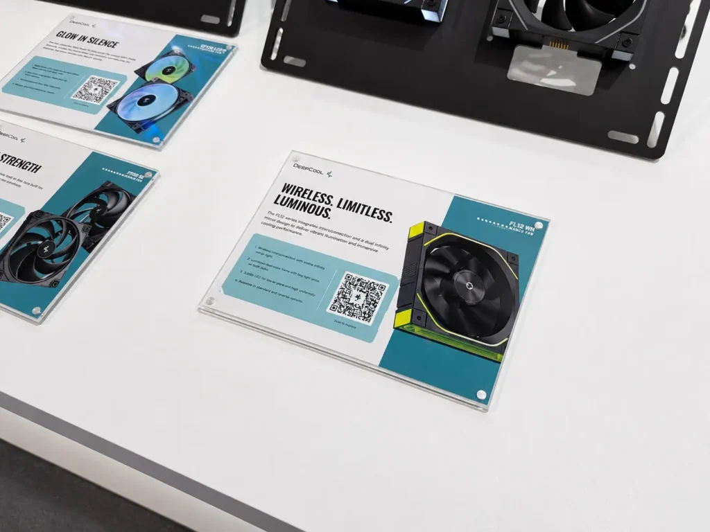 DeepCool FL12 INF and FD12 V2 Fans Bring Cleaner Builds and Quieter Cooling 1 DeepCool FL12 WF wireless RGB cooling fan displayed at a trade show with information card highlighting cable-reduction design and lighting features