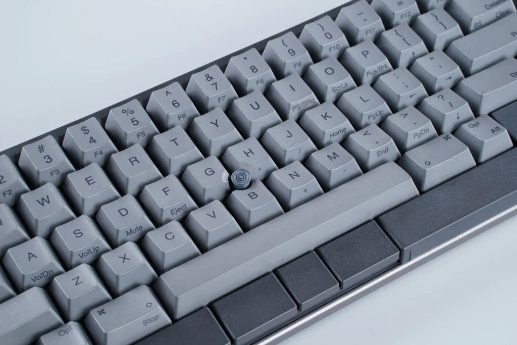 Close-up view of Ash Gray keyboard keycaps and integrated pointing stick