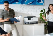 HP Previews RTX Spark OmniBooks, OmniDesk Mini, and New AI Workstations at Computex 2026 HP AI workplace setup featuring business users collaborating beside an HP multifunction printer