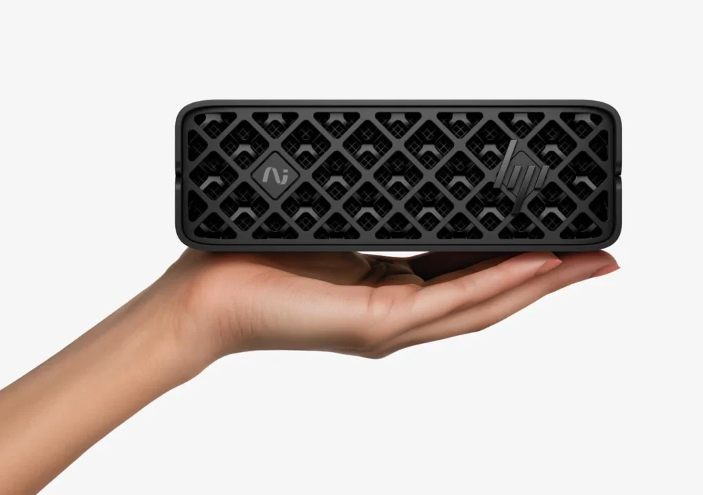 HP OmniDesk Mini compact AI PC shown resting on a hand to highlight its small size