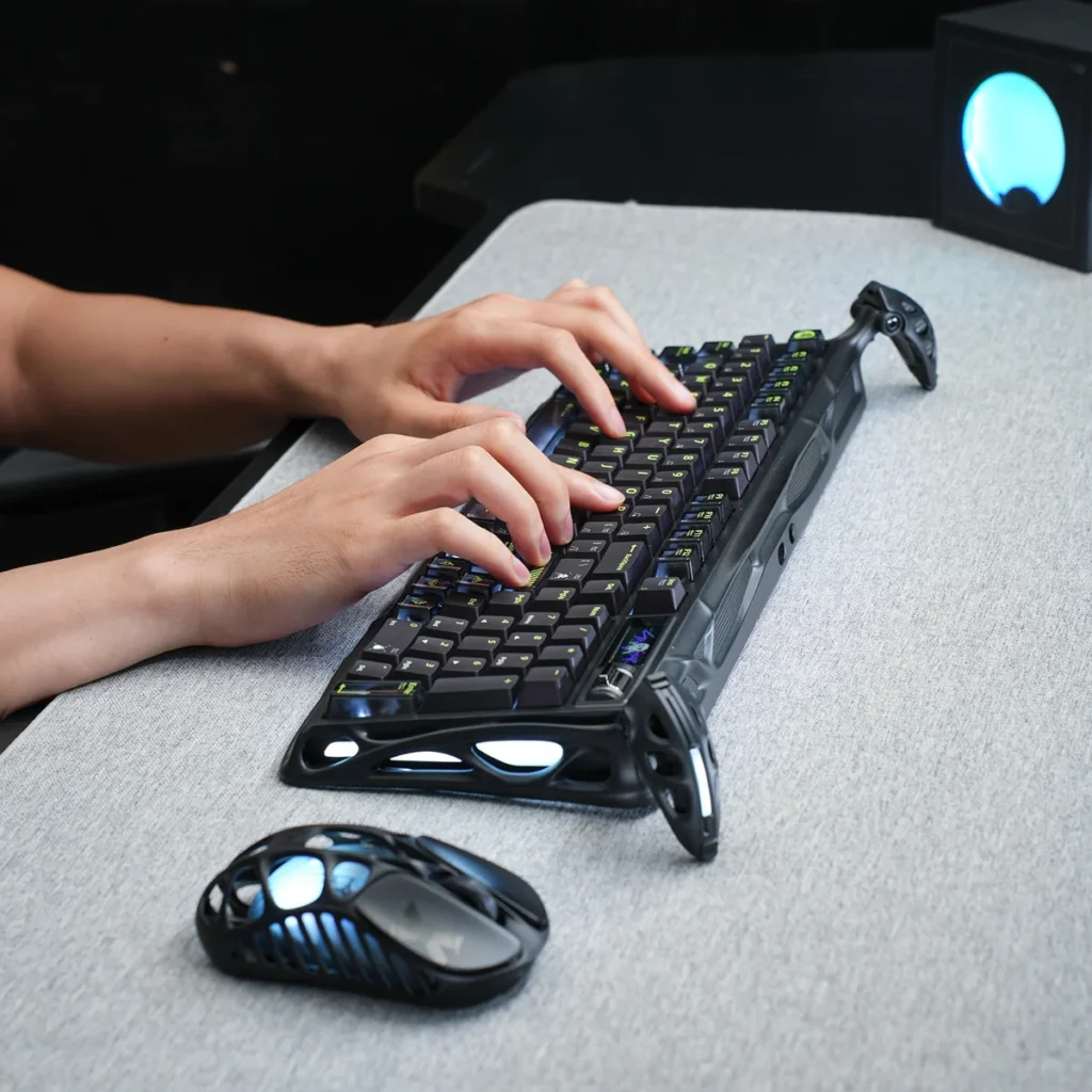 User typing on the GravaStar Mercury K98 Pro mechanical gaming keyboard alongside a matching wireless mouse