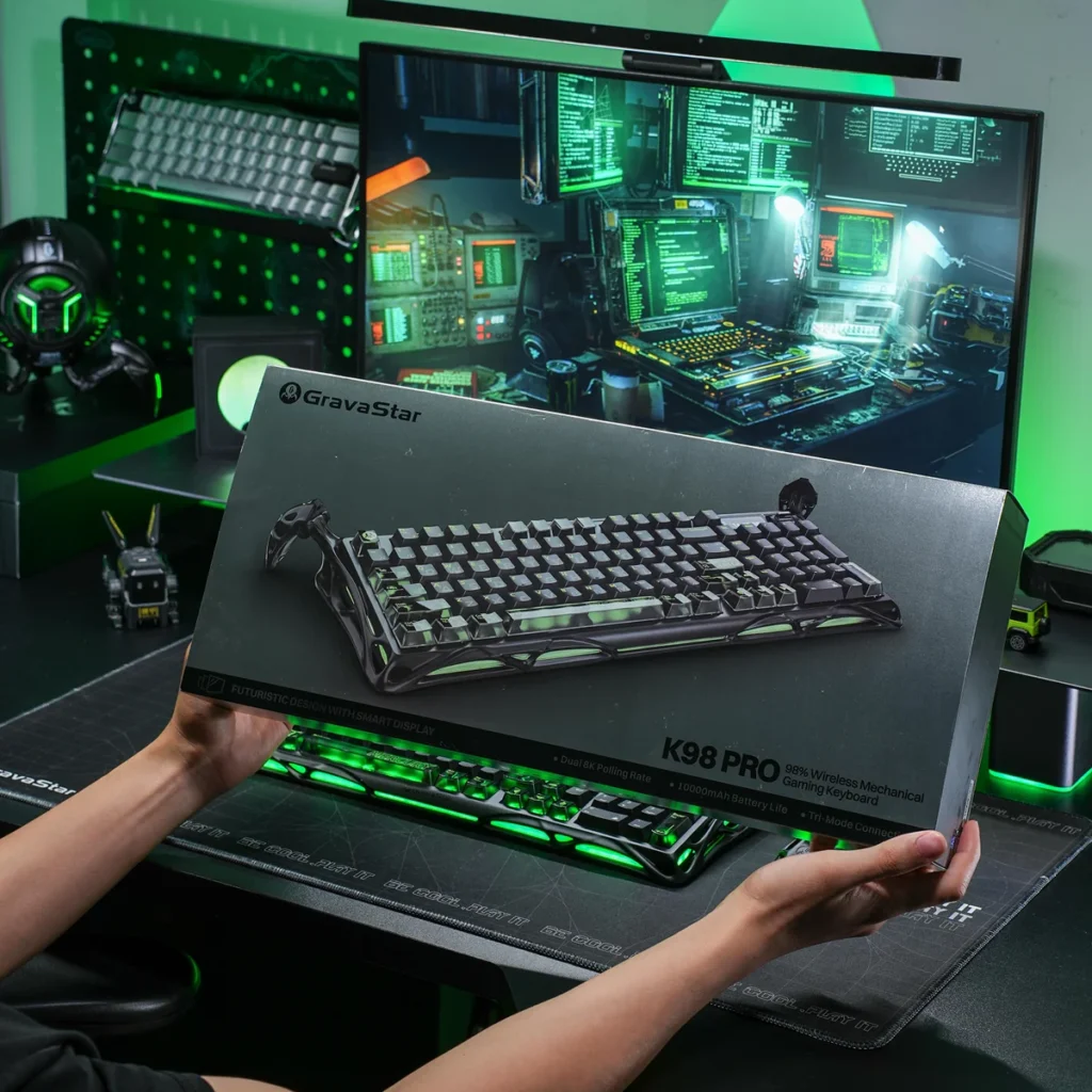 GravaStar Mercury K98 Pro wireless mechanical gaming keyboard retail box displayed in a gaming setup