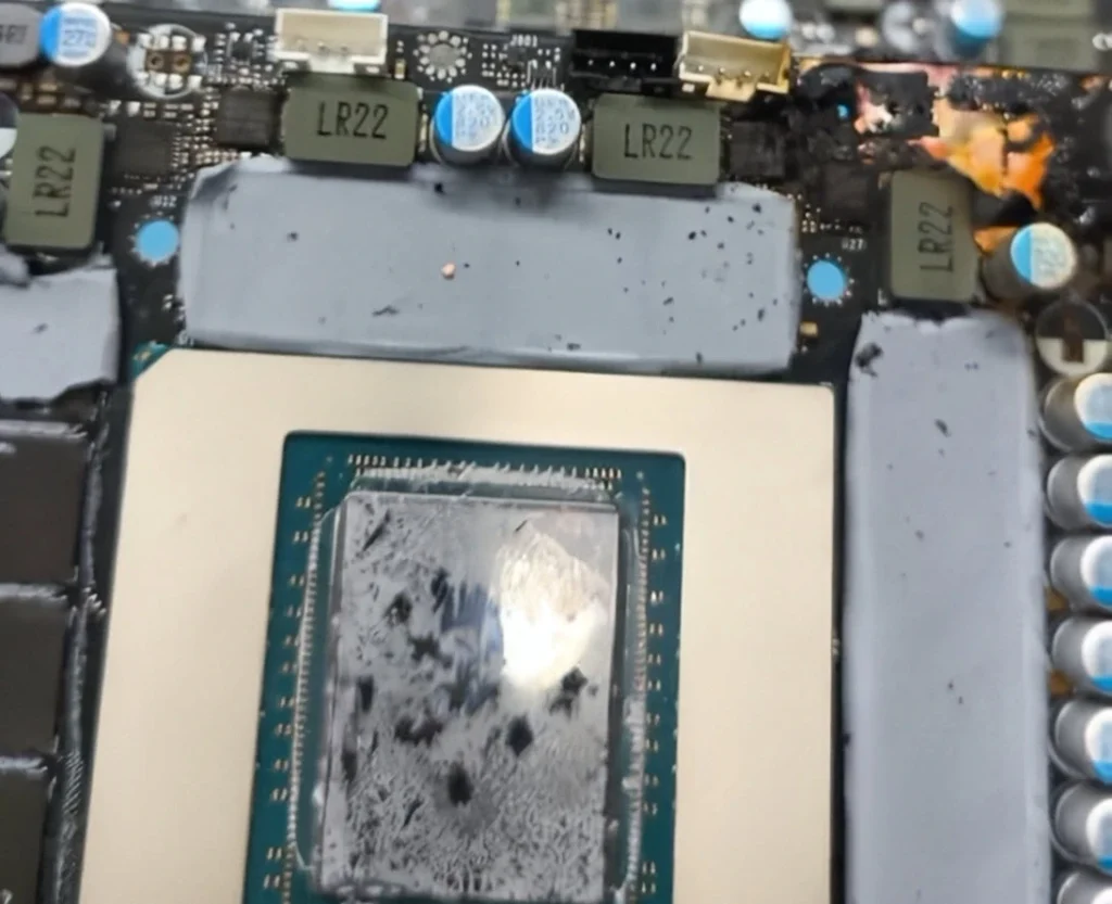 Burned section of an RTX 5090 graphics card PCB near the power delivery components.