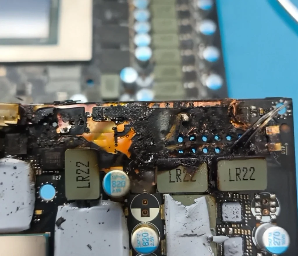 Close-up of severe burn damage on the RTX 5090 graphics card power circuit.