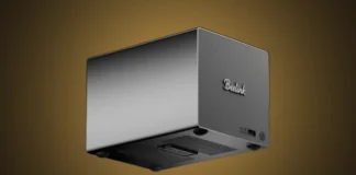 Beelink Launches Affordable ME Pro NAS With 68TB Storage Support The isolated Beelink ME Pro NAS metal enclosure set against a custom warm gold radial gradient spotlight.