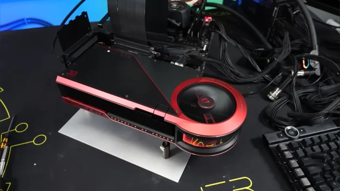 The flagship custom liquid-cooled GeForce graphics card mounted on a test bench next to a keyboard.