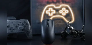 Epomaker Launches Nex Lite Wireless Gaming Mouse The black Epomaker Nex Lite wireless gaming mouse standing on a dark desk with gaming controllers.