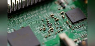PC Brands Expand Chinese Memory Adoption Amid Rising Costs Close-up macro photograph of a green computer motherboard circuit board displaying chips, circuits, and micro-components.