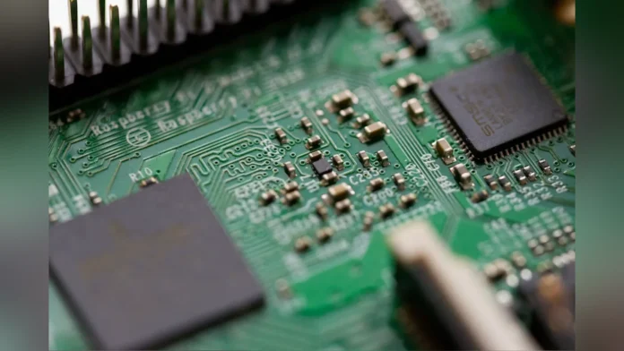 Close-up macro photograph of a green computer motherboard circuit board displaying chips, circuits, and micro-components.