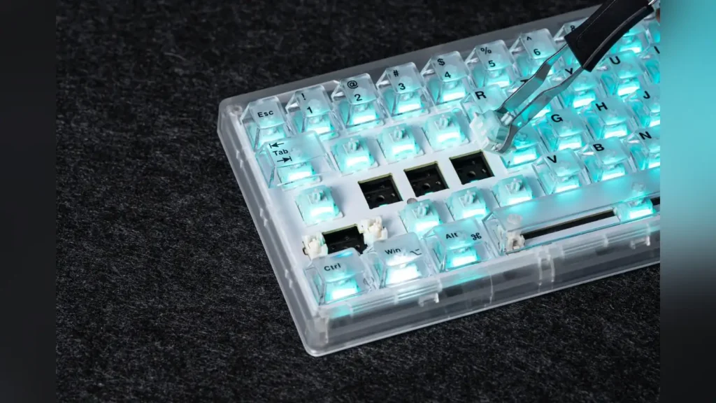 Epomaker Launches NEX Pro Mouse and HE65 V2 TMR Keyboard 1 Close-up of keycaps and switches being swapped on the transparent EPOMAKER HE65 V2 TMR keyboard.