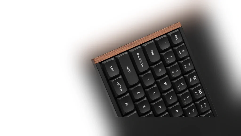 Backplate of the keyboard showing the two-stage flip-out feet and connectivity switches.
