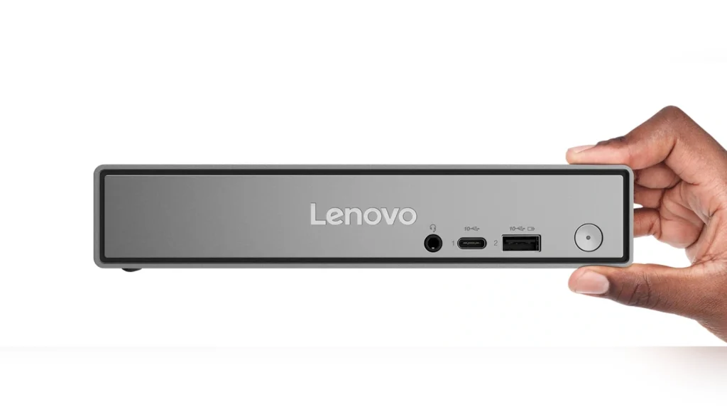 The Lenovo ThinkCentre Neo 50q Gen 6 Tiny PC mounted vertically on a desk stand next to a monitor in an office setup.