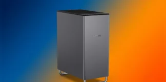 Lenovo Launches ThinkCentre X Tower Workstation With Dual RTX 5060 Ti GPUs Front angled view of the gunmetal gray Lenovo ThinkCentre X Tower workstation chassis with curved metal feet on a blue and orange gradient background.