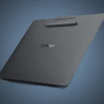 Back view of the isolated gray Lenovo YOGA Pro 15 laptop open under a custom steel blue radial gradient spotlight, showing the attached stylus.