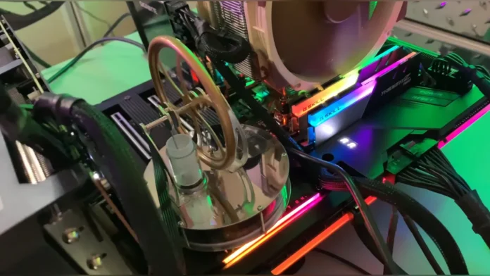 Angled view showing the Stirling engine next to glowing G.Skill Trident Z RGB RAM sticks and the CPU cooler.