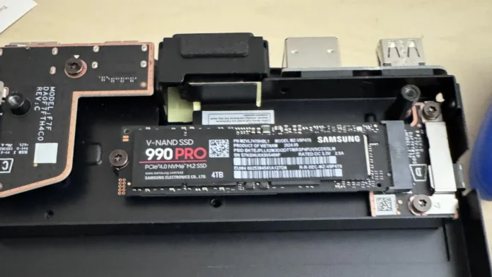 Close-up view of a 4TB Samsung 990 PRO NVMe M.2 SSD installed inside the open chassis of a Steam Machine console.